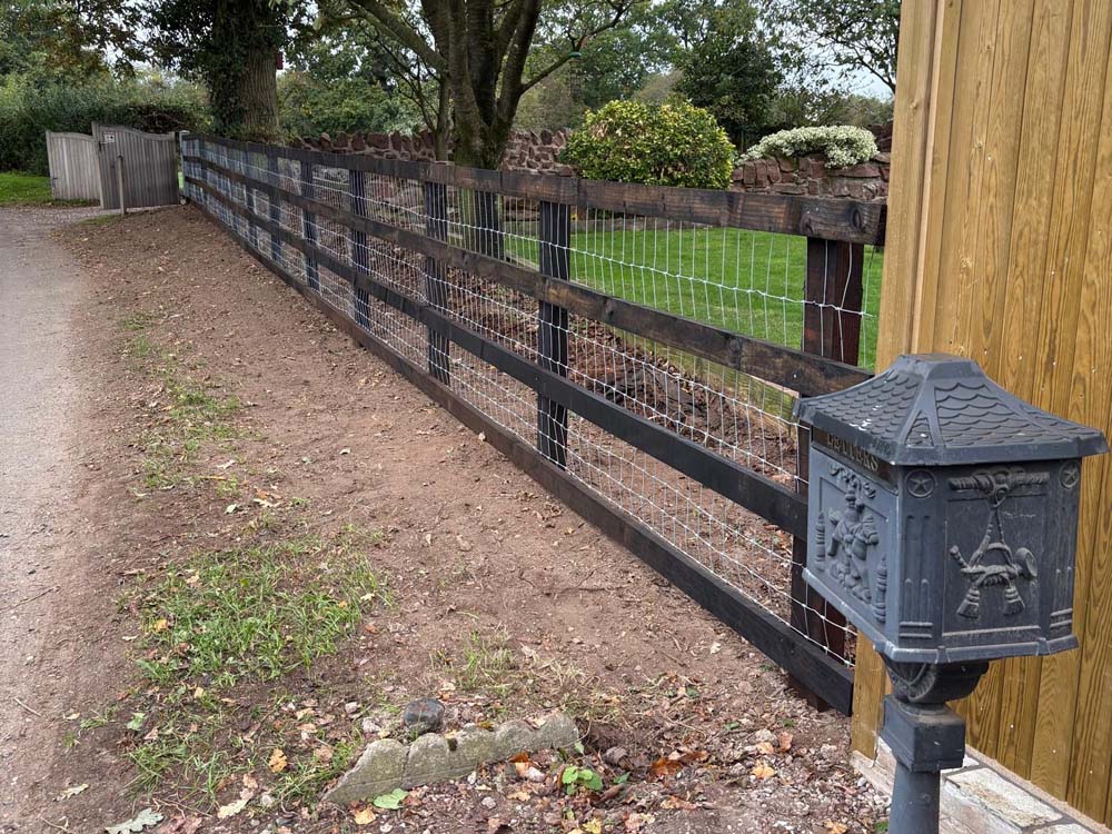 Rotten fencing replaced with dog-proof rails